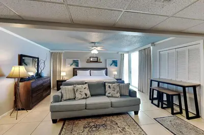 a bedroom with a bed and a couch at Long Beach Resort Tower I #900E in Panama City Beach