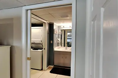 a bathroom with a sink and a mirror at Long Beach Resort Tower I #900E in Panama City Beach