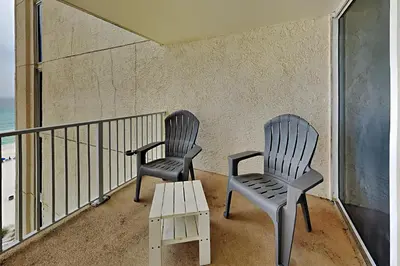 two chairs and a table on a balcony at Long Beach Resort Tower I #900E in Panama City Beach