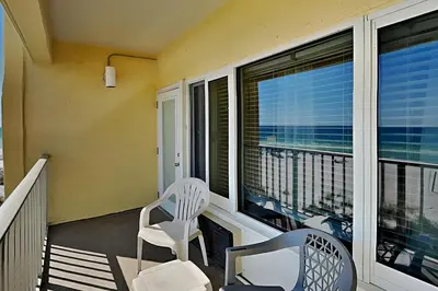 a balcony with two chairs and a view of the ocean at Continental 319 in Panama City Beach