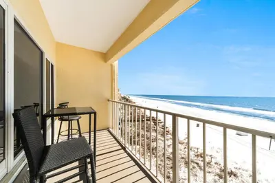 a balcony with a table and chairs and the beach at Continental 419 in Panama City Beach