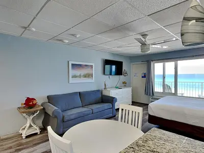 a bedroom with a bed and a couch and a table at Continental Condominiums 3 in Panama City Beach