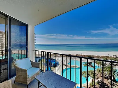 a balcony with a table and a view of the ocean at Edgewater Tower I 704 in Panama City Beach