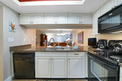 a kitchen with a sink and a stove top oven at Edgewater Tower I 704 in Panama City Beach