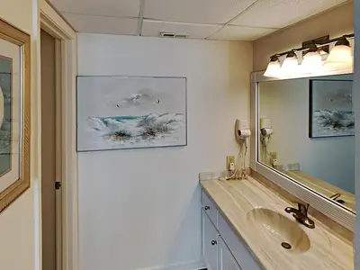 a bathroom with a sink and a mirror at Edgewater Tower I 904 in Panama City Beach