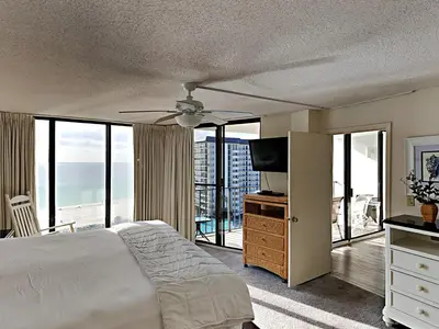 a bedroom with a bed with a ceiling fan at Edgewater Tower I 904 in Panama City Beach