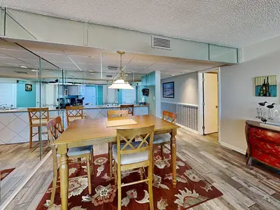 a dining room and kitchen with a table and chairs at Edgewater Tower II #204 in Panama City Beach