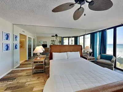 a bedroom with a large bed with a ceiling fan at Edgewater Tower II #204 in Panama City Beach