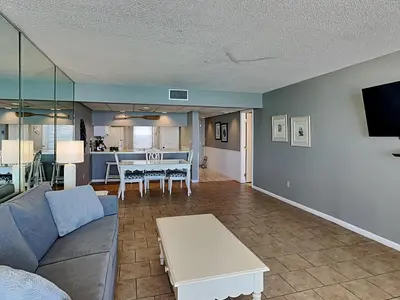 a living room with a couch and a table at Edgewater Tower II 1004 in Panama City Beach