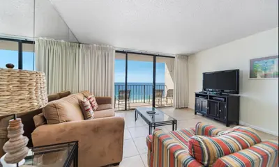 a living room with a couch and a flat screen tv at Edgewater Tower III #606 in Panama City Beach