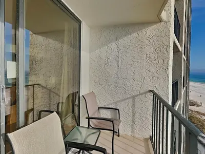 a balcony with chairs and a view of the beach at Edgewater Tower III #606 in Panama City Beach