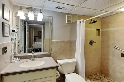 a bathroom with a toilet and a sink and a shower at Edgewater Tower III #607 in Panama City Beach