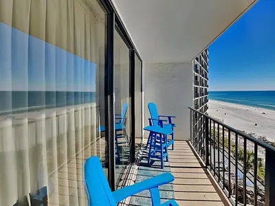 a balcony with blue chairs and the beach at Edgewater Tower III #608 in Panama City Beach