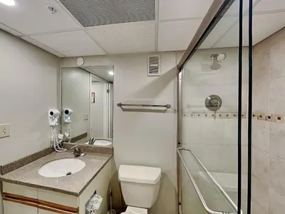 a bathroom with a toilet and a sink and a shower at Edgewater Tower III #609 in Panama City Beach