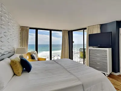 a bedroom with a large bed and a television at Edgewater Tower III #704 in Panama City Beach