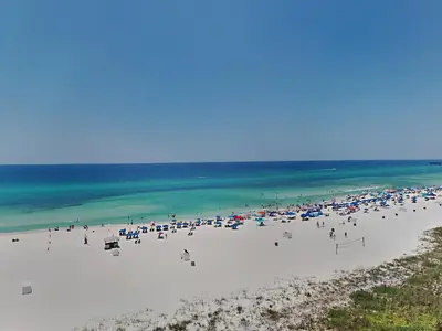 a group of people on a beach with the ocean at Edgewater Tower III #704 in Panama City Beach