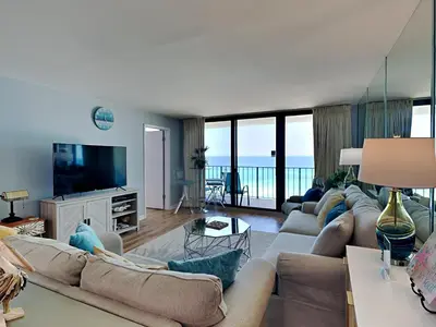 a living room with a couch and a television at Edgewater Tower III #704 in Panama City Beach