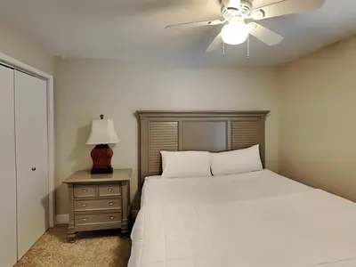 a bedroom with a bed and a ceiling fan at Edgewater Tower III 707 in Panama City Beach