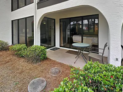 a patio with a table and chairs in a house at Edgewater Villa #704 in Panama City Beach