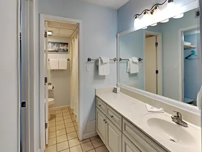 a bathroom with a sink and a mirror at Edgewater Villa #704 in Panama City Beach