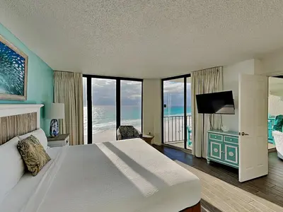 a bedroom with a bed with a view of the ocean at Edgewater Tower III #804 in Panama City Beach