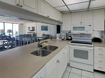 a kitchen with a sink and a stove top oven at Edgewater Tower III #804 in Panama City Beach