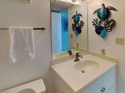 a bathroom with a sink and a mirror at Edgewater Tower III #804 in Panama City Beach