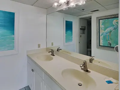 a bathroom with two sinks and a large mirror at Edgewater Tower III #804 in Panama City Beach