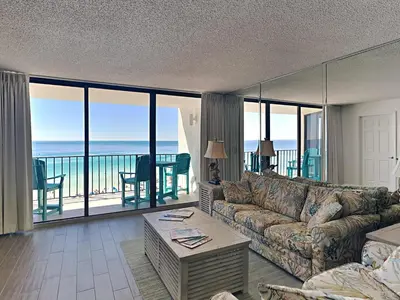 a living room with a couch and a view of the ocean at Edgewater Tower III #804 in Panama City Beach
