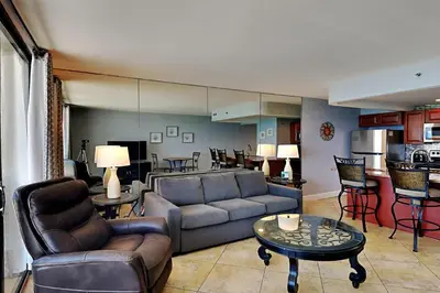 a living room with a couch and a table at Edgewater Tower III 907 in Panama City Beach