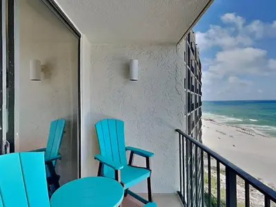a balcony with chairs and a view of the beach at Edgewater Tower III 907 in Panama City Beach