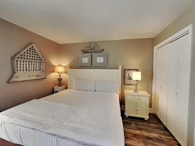 a bedroom with a large white bed and two lamps at Edgewater Tower III 1006 in Panama City Beach