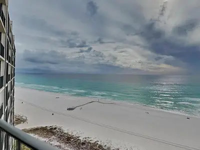 a view of the beach from the balcony of a building at Edgewater Tower III 1006 in Panama City Beach