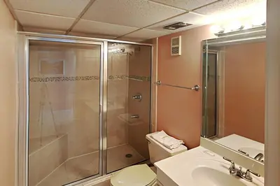 a bathroom with a shower and a toilet and a sink at Edgewater Tower III 1106 in Panama City Beach