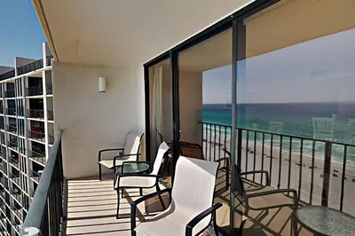 a balcony with chairs and a view of the beach at Edgewater Tower III 1106 in Panama City Beach
