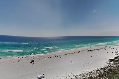 a group of people on a beach near the ocean at Edgewater Tower III 1106 in Panama City Beach