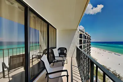 a balcony with chairs and a view of the beach at Edgewater Tower III 1108 in Panama City Beach