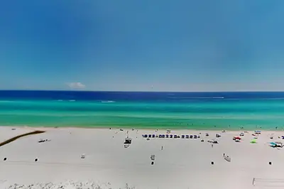 a beach with a lot of people and the ocean at Edgewater Tower III 1108 in Panama City Beach