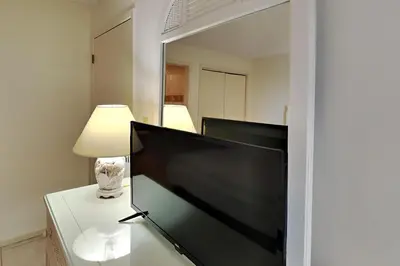 a television sitting on a table in front of a mirror at Edgewater Tower III 1108 in Panama City Beach