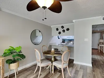 a dining room with a table and chairs at Edgewater Leeward #605 in Panama City Beach