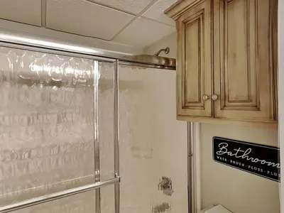 a bathroom with a shower with a glass door at Edgewater Leeward #605 in Panama City Beach