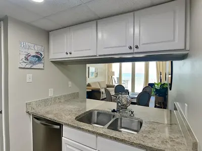 a kitchen with a sink and a counter top at Edgewater Leeward #605 in Panama City Beach