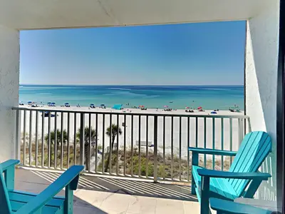 a balcony with two chairs and a view of the beach at Edgewater Windward #305 in Panama City Beach