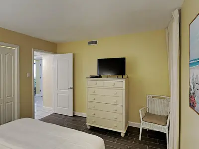 a bedroom with a bed and a tv on a dresser at Edgewater Windward #305 in Panama City Beach