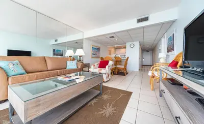 a living room with a couch and a tv at Edgewater Windward #603 in Panama City Beach