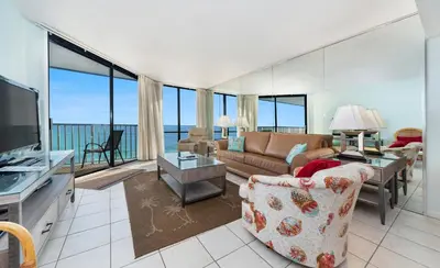 a living room with a couch and a television at Edgewater Windward #603 in Panama City Beach
