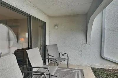 a group of chairs sitting on a patio at Edgewater Villa #306 in Panama City Beach