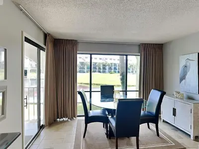 a dining room with a table and chairs at Edgewater Villa #404 in Panama City Beach
