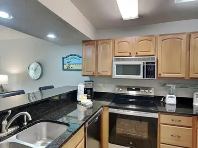 a kitchen with a sink and a microwave at Edgewater Villa #404 in Panama City Beach