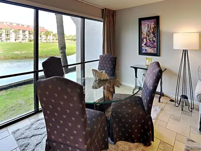 a dining room with a glass table and two chairs at Edgewater Villa #404 in Panama City Beach
